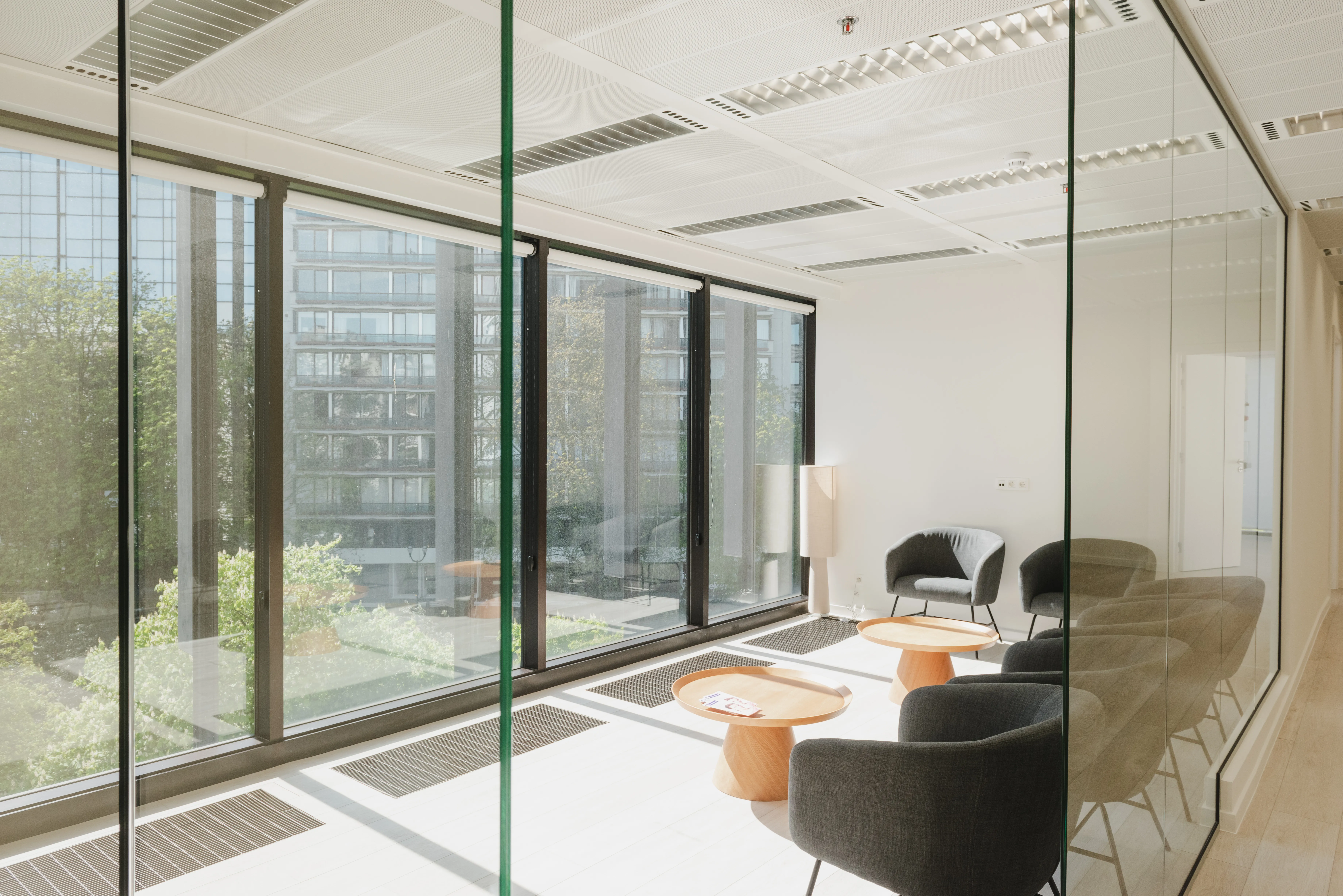 Bright modern office meeting room with glass walls and natural light