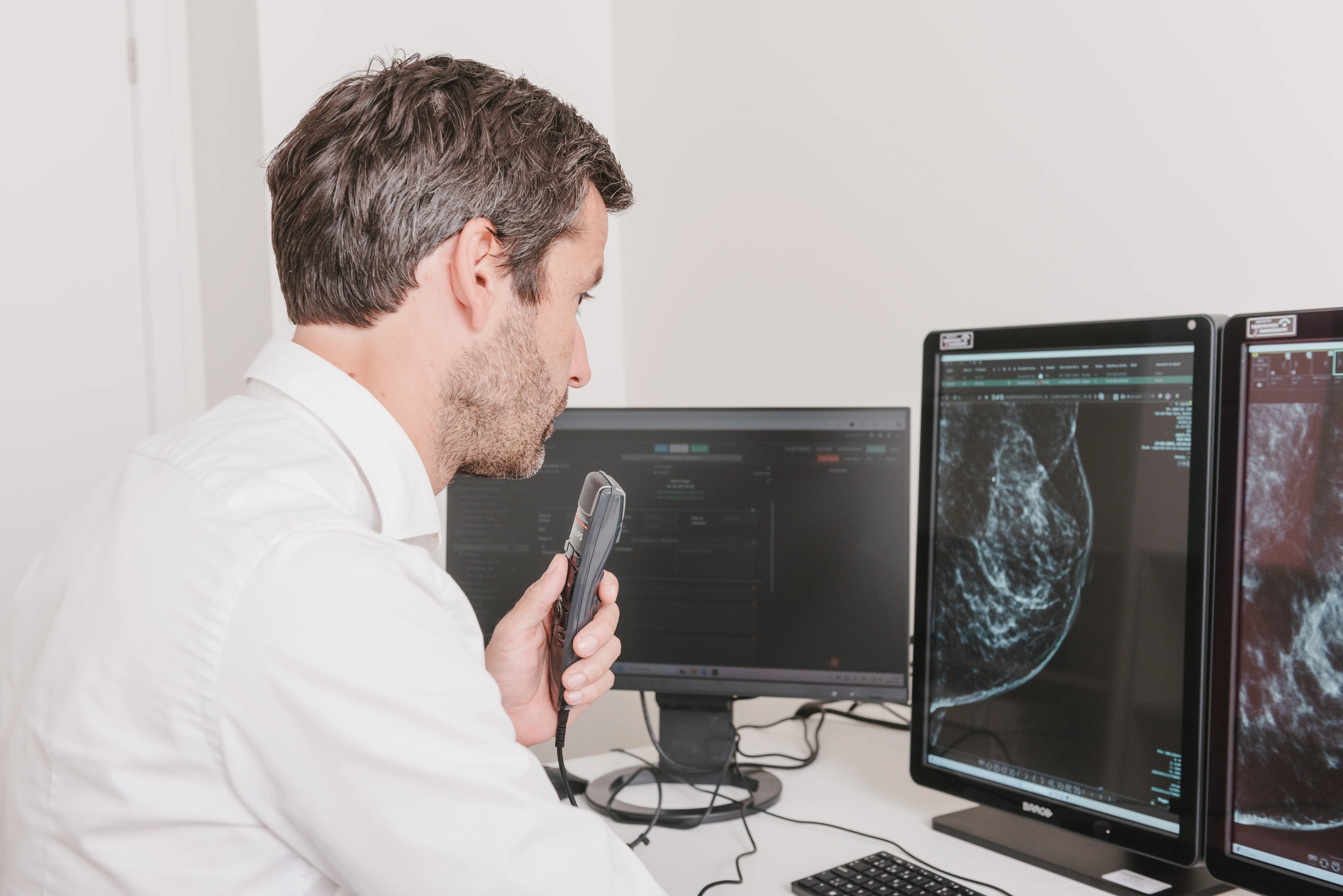 Radiologist reporting at a diagnostic workstation in one of the network's practices